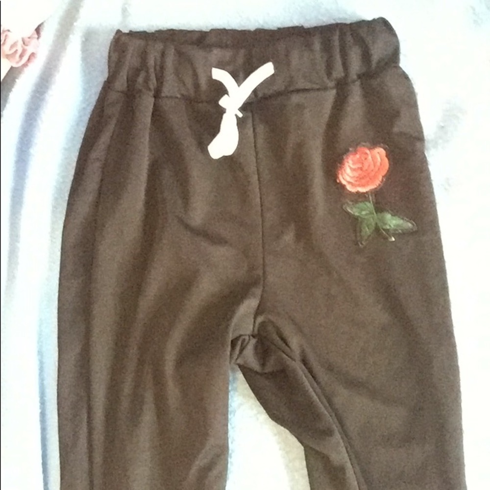 Brand new black sweats with cute rose detail.